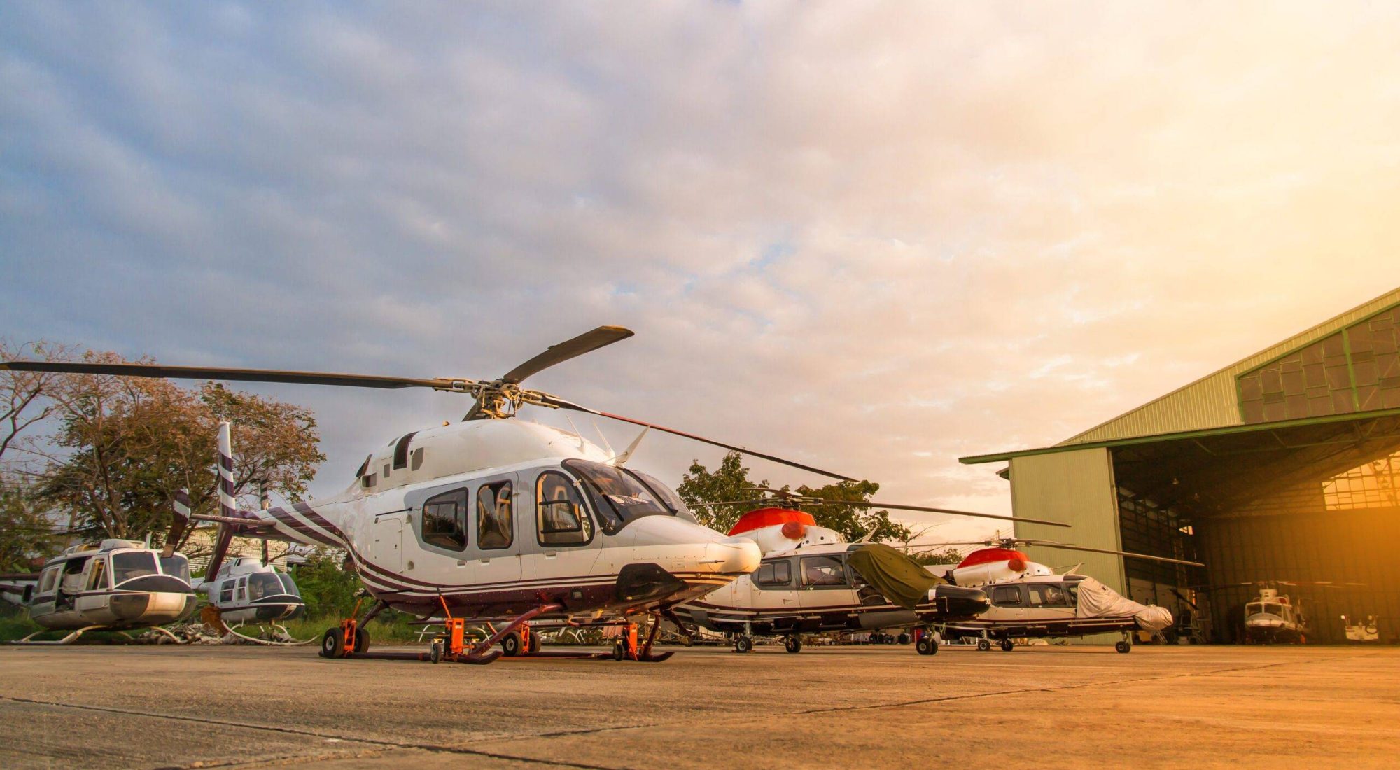 helicopter-parking-lot-runway-waiting-maintenance-with-sunrise-background-scaled.jpg